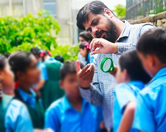 a volunteer showing something to group of people